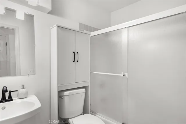 a spacious bathroom with a tub sink and mirror