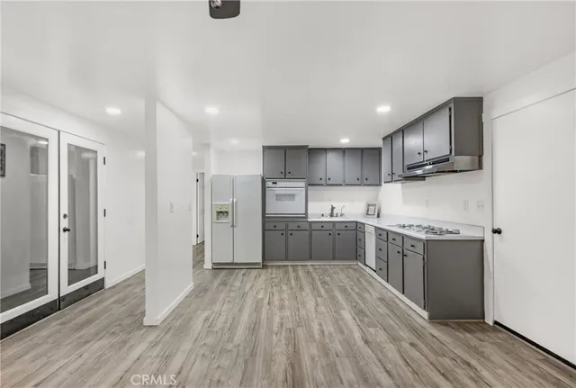 a view of an empty room and wooden floor