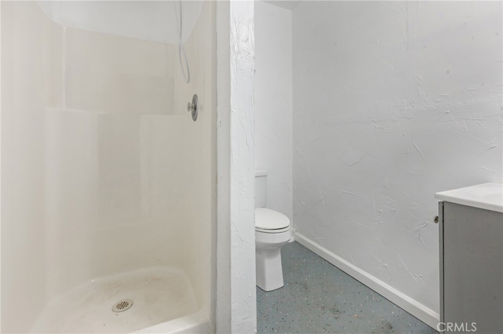 508 Mesa View Drive Arroyo Grande, CA 93420 - Photo 49 of 55 a bathroom with a granite countertop toilet and a shower