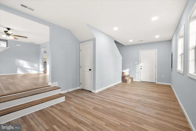 a view of a hallway with wooden floor