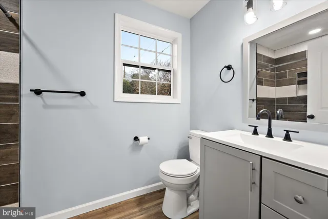 a bathroom with a toilet sink and mirror