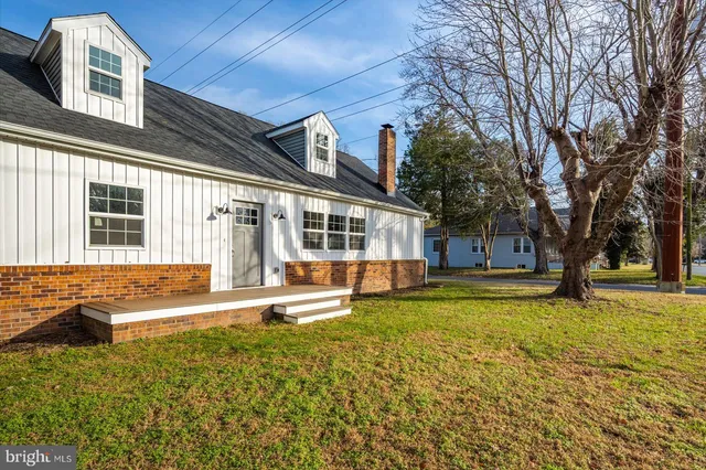 a view of a house with a yard patio and fire pit