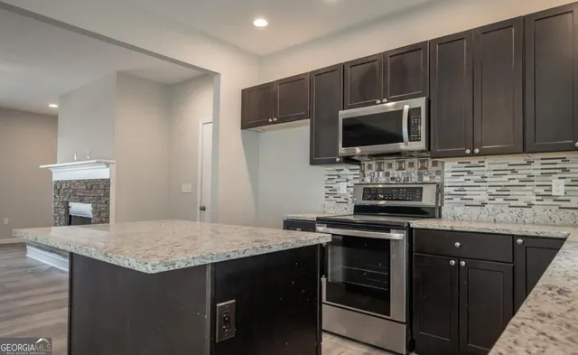 a kitchen with a stove microwave and sink