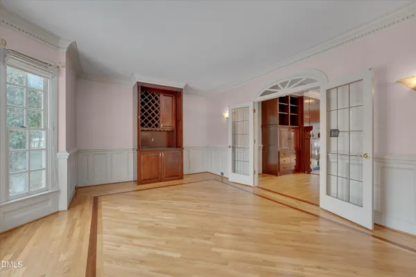 an empty room with windows cabinet and fireplace