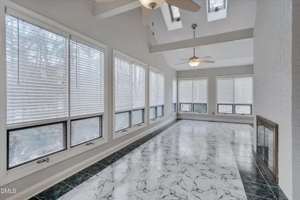 a large kitchen with granite countertop a large counter top appliances and cabinets