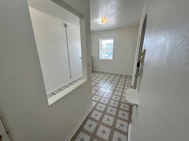 a kitchen with cabinets and white stove