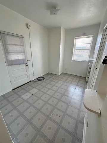 a kitchen with a refrigerator and a stove