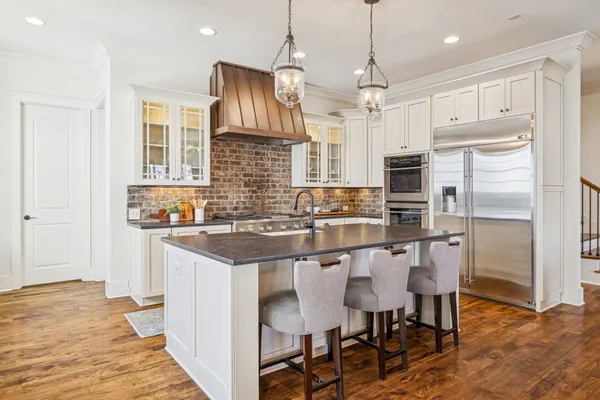 a kitchen with granite countertop a sink stove and cabinets