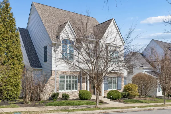 a view of a house with a tree in front