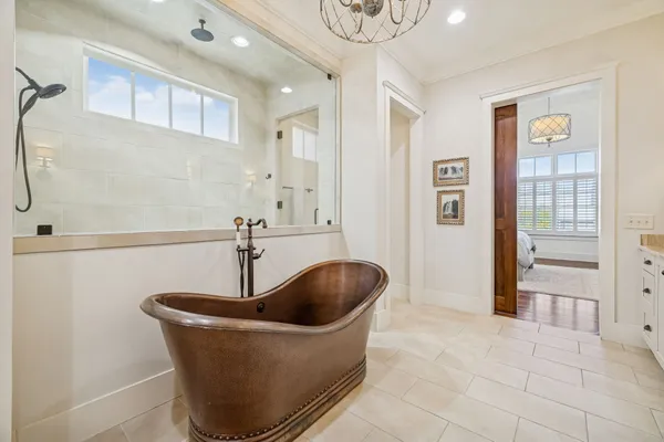 a bathroom with a granite countertop sink toilet a large mirror a shower and a bathtub