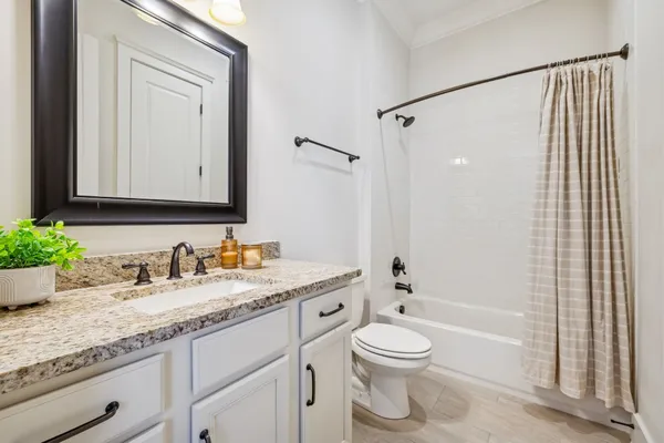 a kitchen with white cabinets and sink