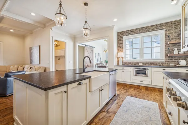 a kitchen with cabinets a center island and appliances