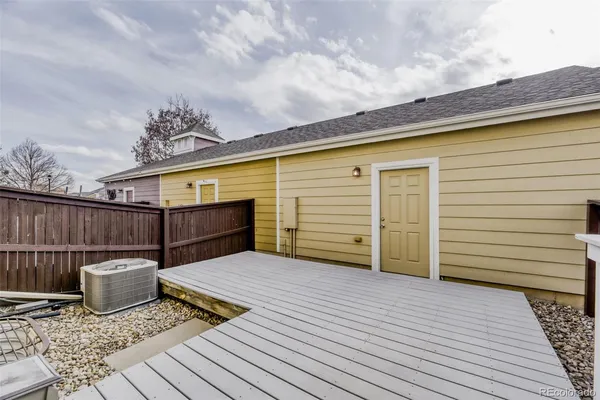 a kitchen with stainless steel appliances granite countertop a stove top oven a sink dishwasher a refrigerator and a microwave oven with wooden floor