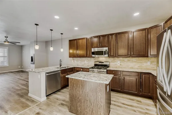 a kitchen with a refrigerator stove and microwave