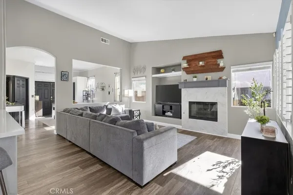 a living room with fireplace furniture and a large window