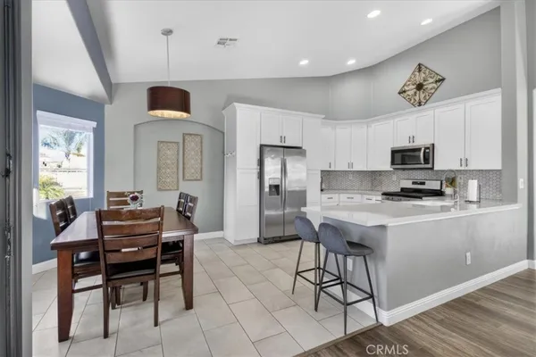 a kitchen with stainless steel appliances a stove microwave and sink