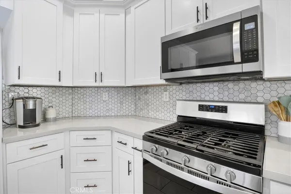 a bedroom with a bed and a flat tv screen on dresser