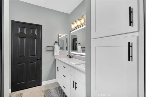 a view of a backyard with potted plants and large tree