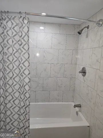 a close up of a bathtub curtain