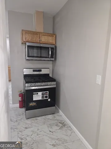 a kitchen with a stove and a microwave