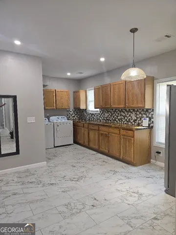 a kitchen with stainless steel appliances granite countertop a stove sink and cabinets
