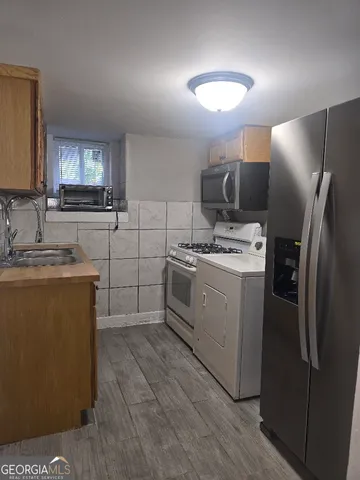 a kitchen with a sink cabinets and stainless steel appliances