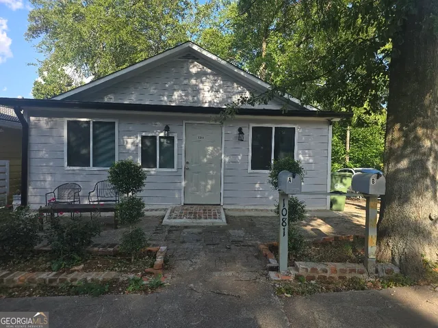 a view of a patio with table and chairs with wooden floor and fence