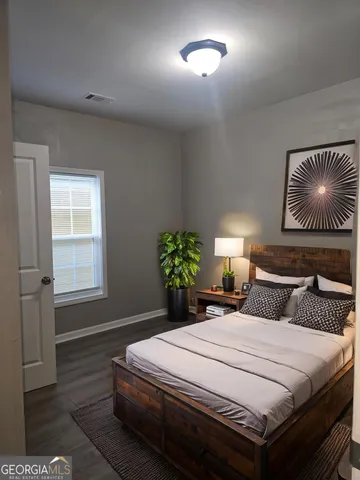 a bedroom with a bed and a lamp