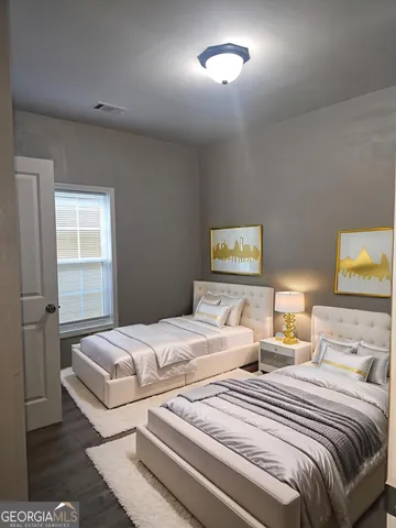 a bedroom with two beds and a night stand