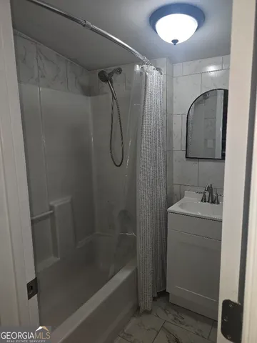 a bathroom with a shower and a sink