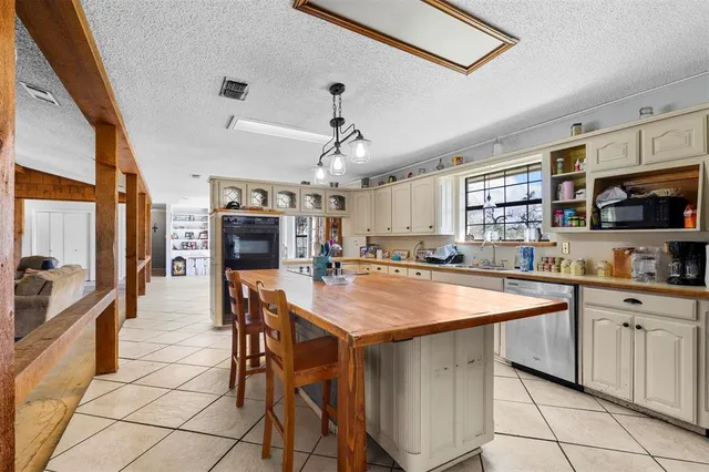 a living room with furniture a clock on wall and a large window