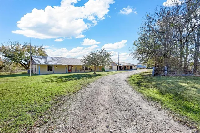 a front view of house with yard and trees