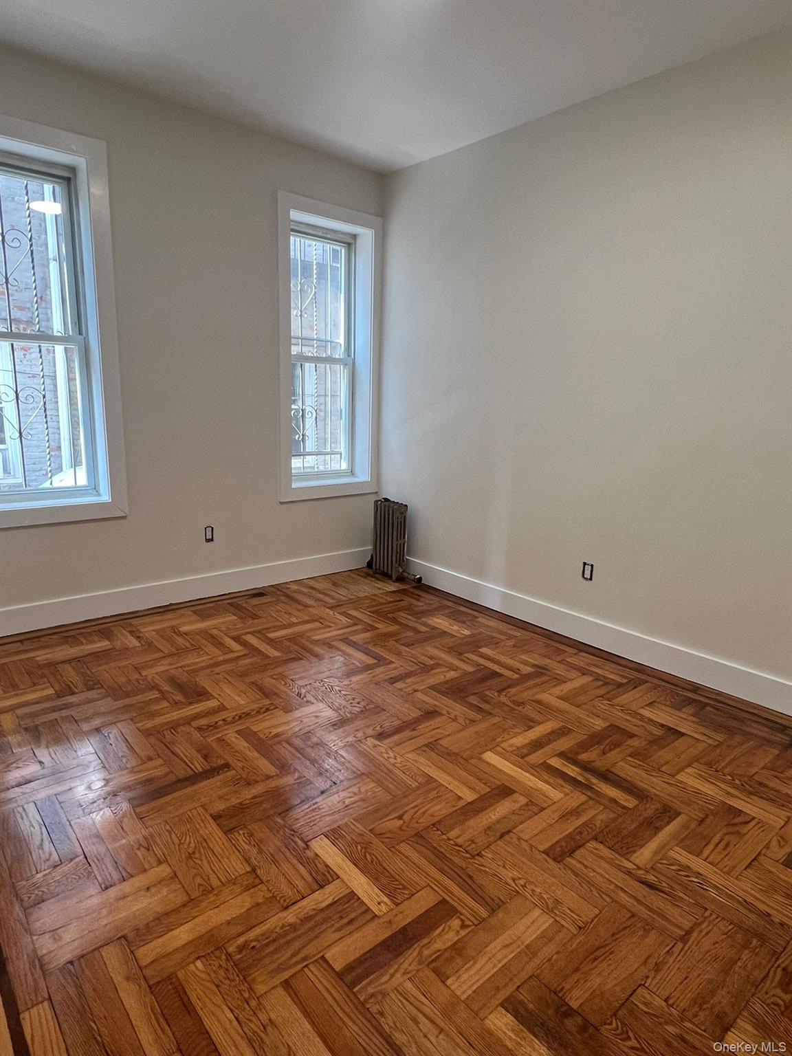 486 East 95th Street, Unit 1R Brooklyn, NY 11212 - Photo 2 of 12 a view of empty room with wooden floor and fan
