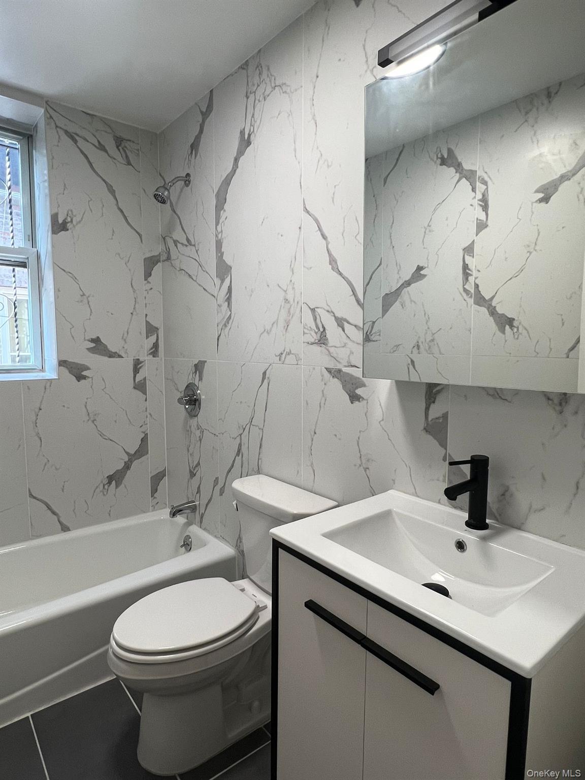 486 East 95th Street, Unit 1R Brooklyn, NY 11212 - Photo 6 of 12 a bathroom with a sink toilet and shower