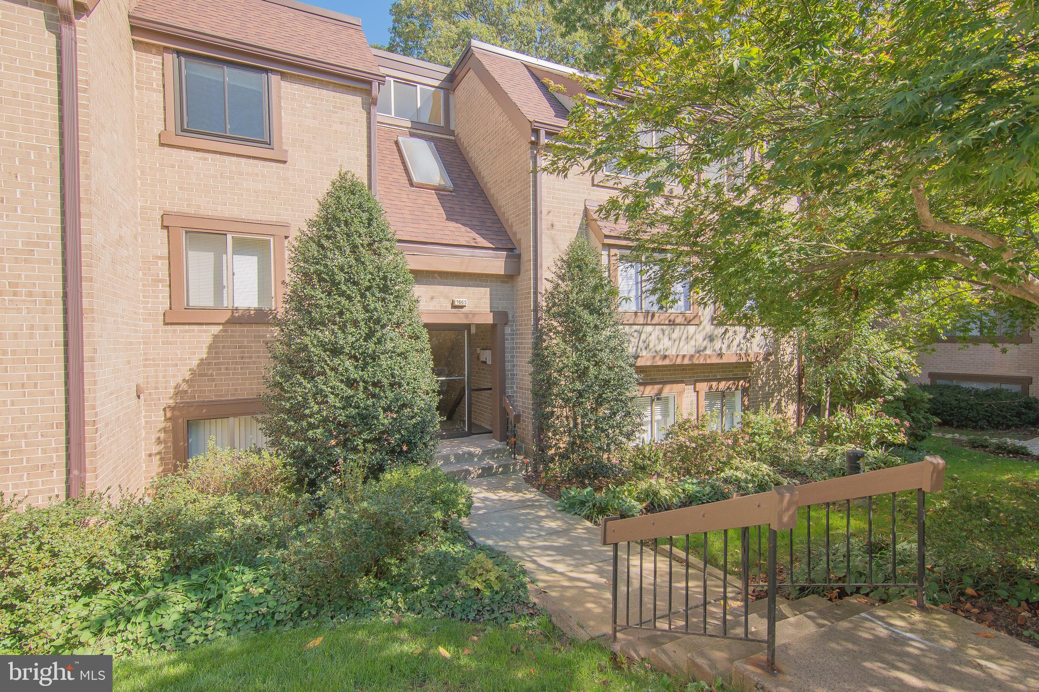 1665 Parkcrest Circle, Unit 301 Reston, VA 20190 - Photo 1 of 30 a view of a house with a yard