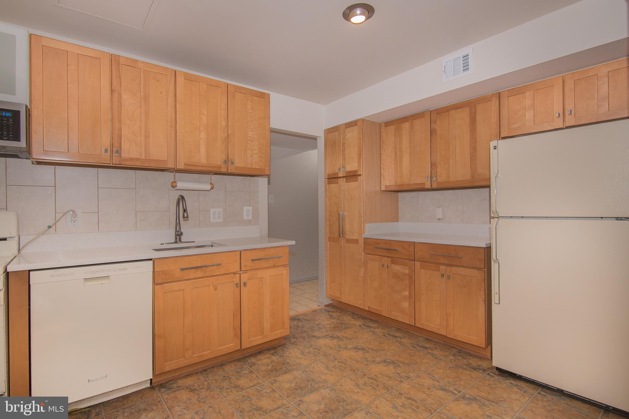 1665 Parkcrest Circle, Unit 301 Reston, VA 20190 - Photo 12 of 30 a kitchen with stainless steel appliances granite countertop a refrigerator sink stove and cabinets