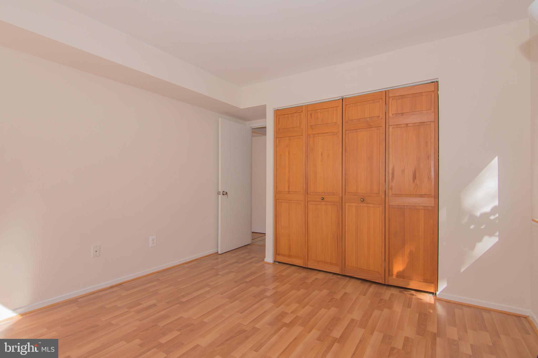 1665 Parkcrest Circle, Unit 301 Reston, VA 20190 - Photo 15 of 30 a view of an empty room with wooden floor