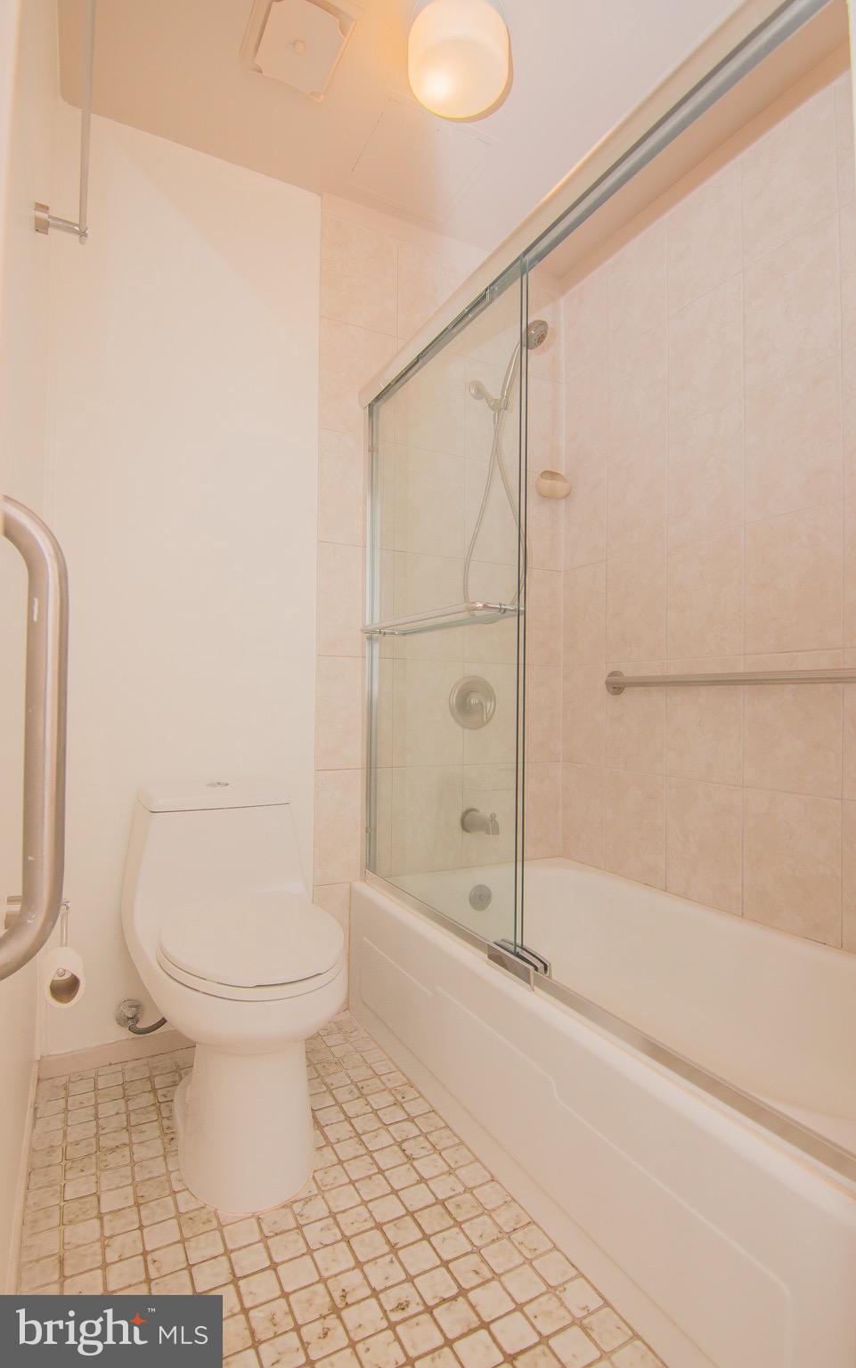 1665 Parkcrest Circle, Unit 301 Reston, VA 20190 - Photo 18 of 30 a bathroom with a toilet and a shower