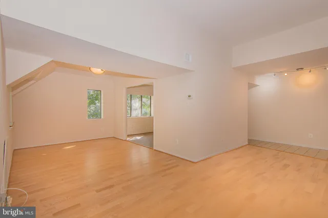 an empty room with windows and closet