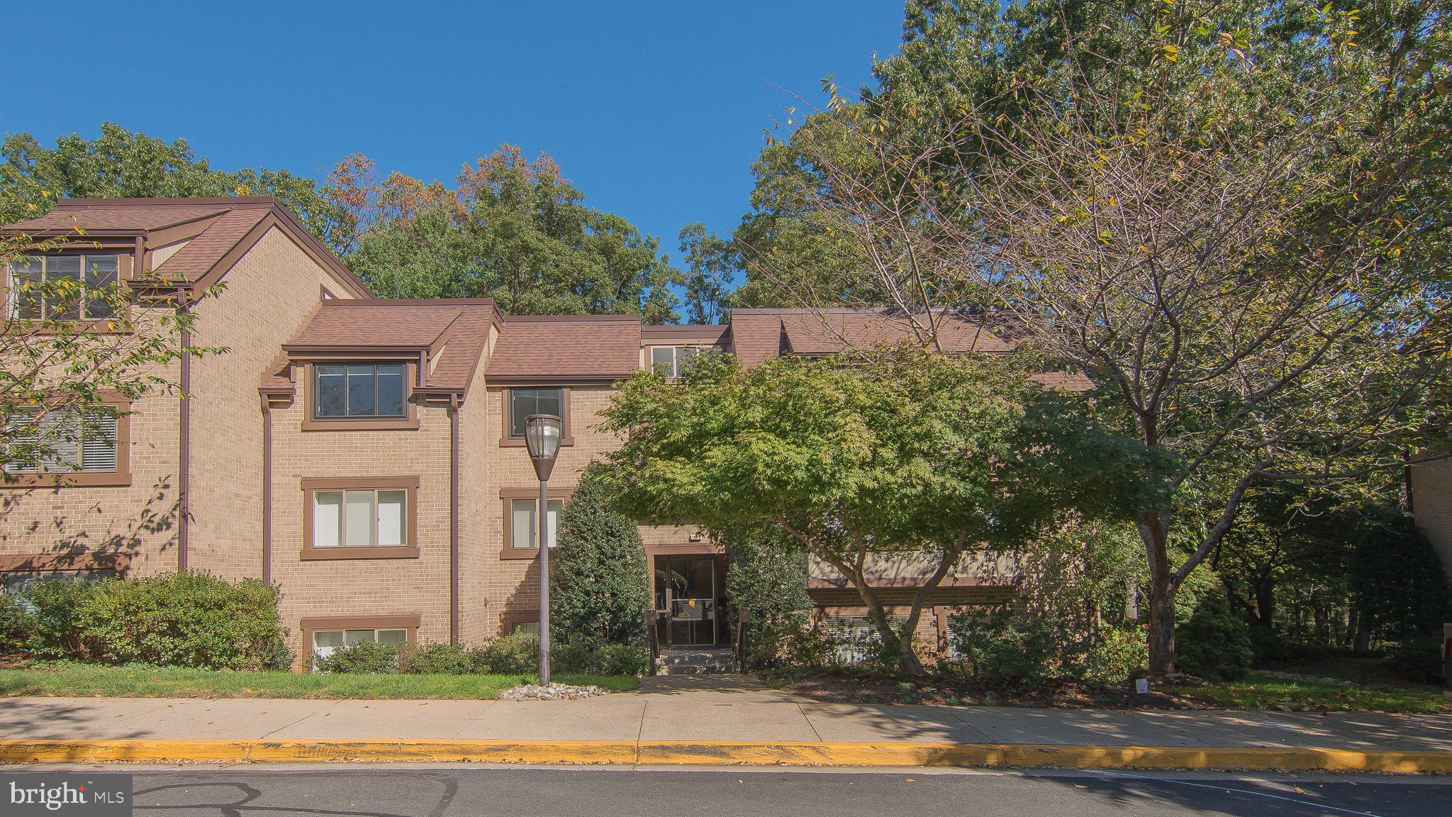1665 Parkcrest Circle, Unit 301 Reston, VA 20190 - Photo 28 of 30 a front view of a house with a yard