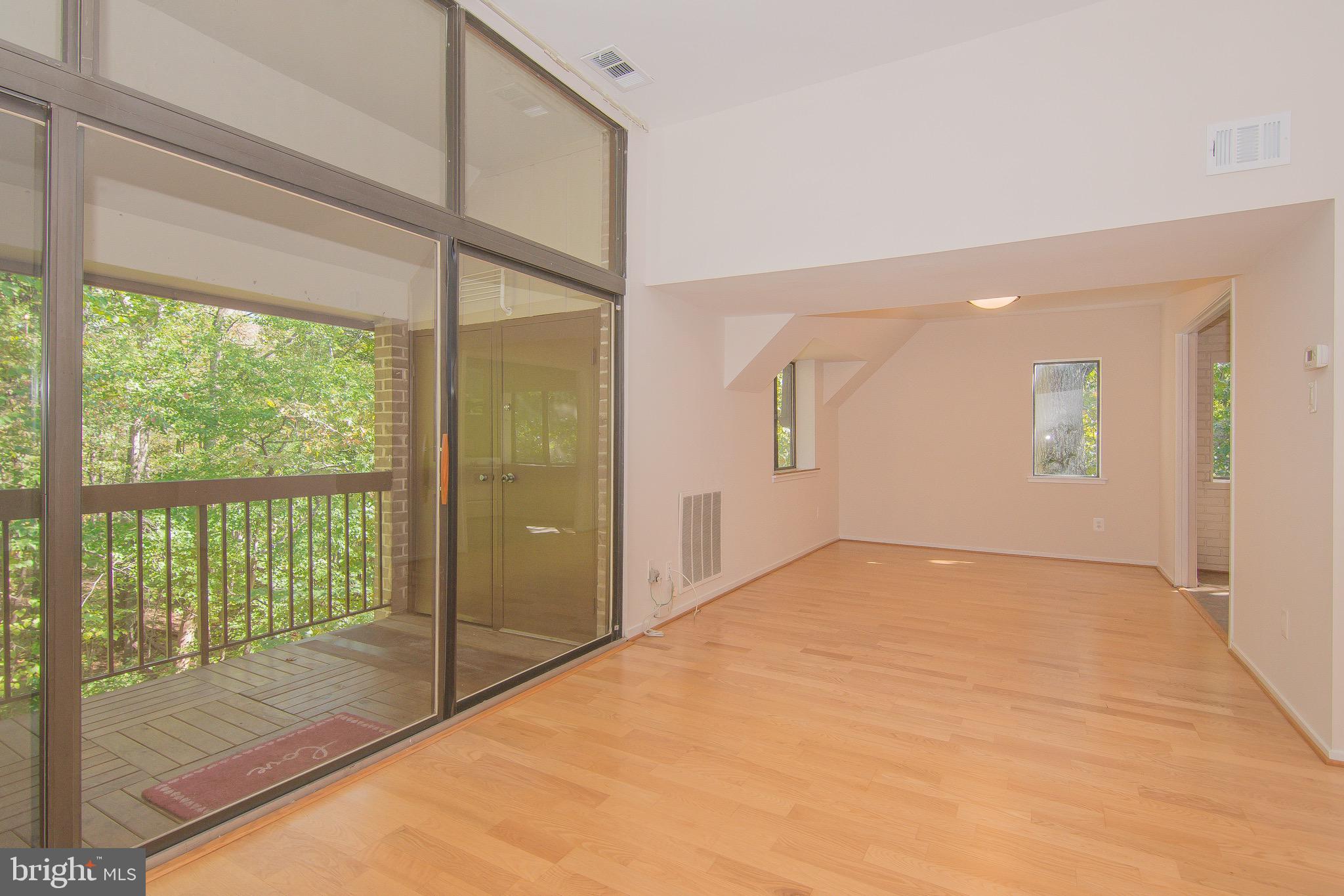 1665 Parkcrest Circle, Unit 301 Reston, VA 20190 - Photo 3 of 30 a view of an empty room and a balcony