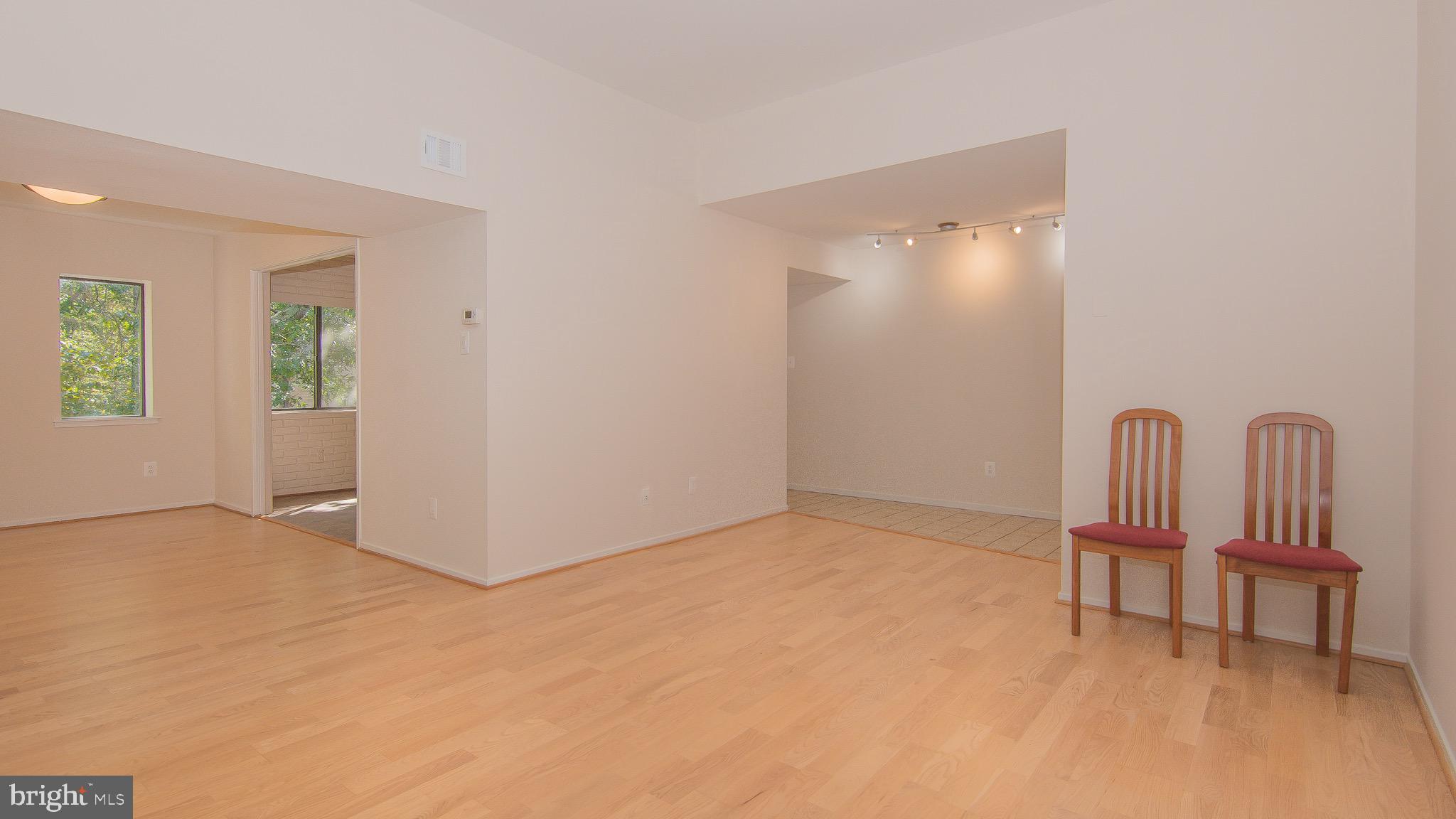 1665 Parkcrest Circle, Unit 301 Reston, VA 20190 - Photo 5 of 30 a view of an empty room with a birdcage and a window