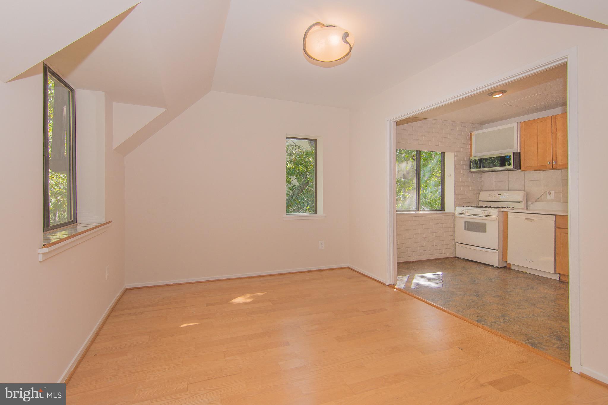 1665 Parkcrest Circle, Unit 301 Reston, VA 20190 - Photo 6 of 30 an empty room with windows and cabinet