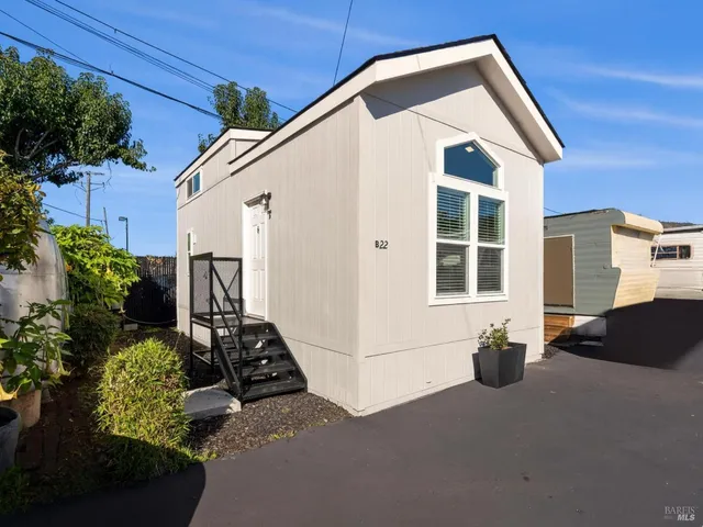 a view of backyard of house with outdoor seating