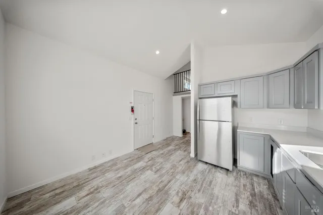 a view of a kitchen with a refrigerator a stove top oven and a refrigerator