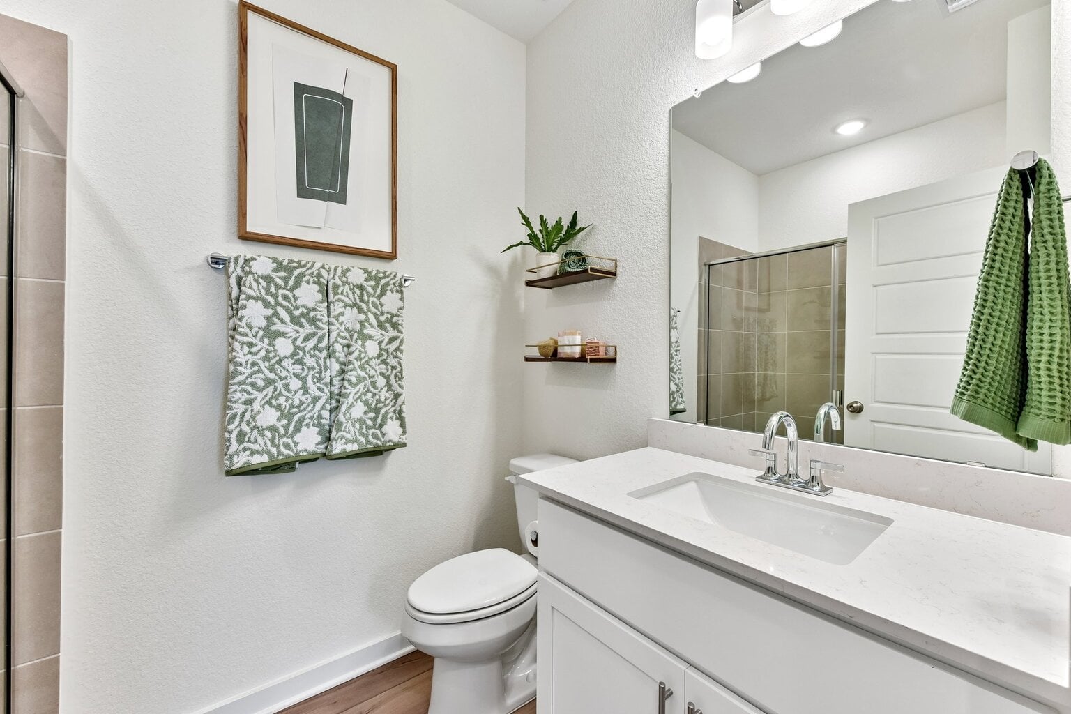 10609 Trifecta Way Buda, TX 78610 - Photo 10 of 17 A well-appointed bathroom boasts a bright vanity with ample counter space and a modern shower enclosure.