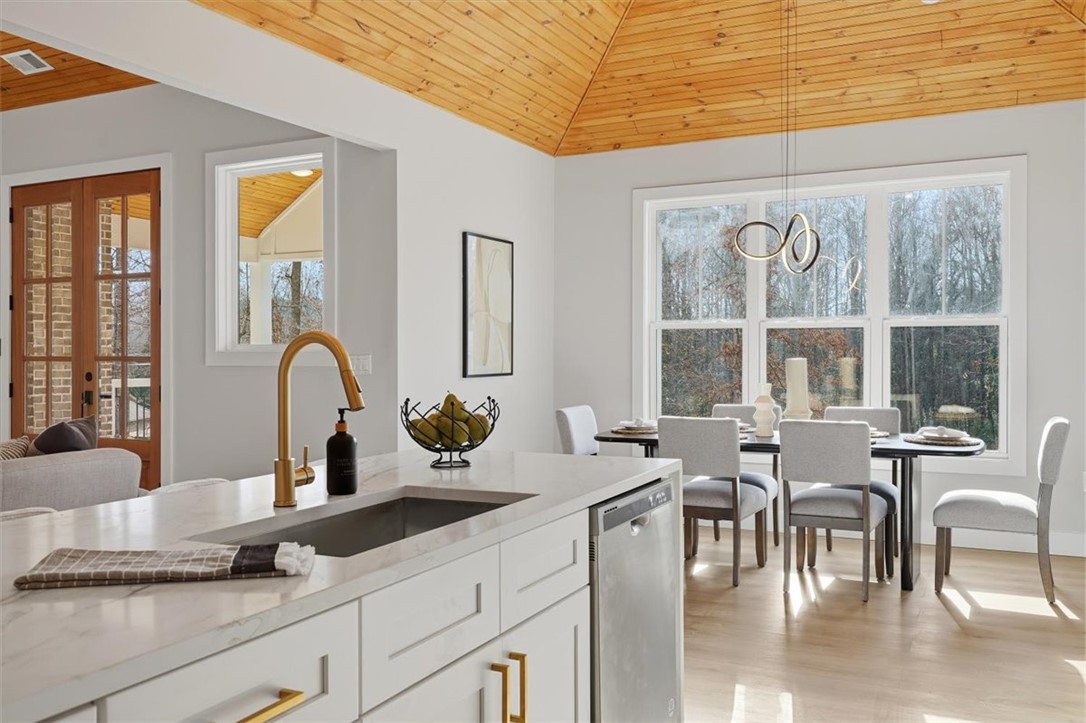 304 Avenue Of Oaks Anderson, SC 29621 - Photo 13 of 38 This spacious kitchen and dining area features abundant natural light and modern finishes.