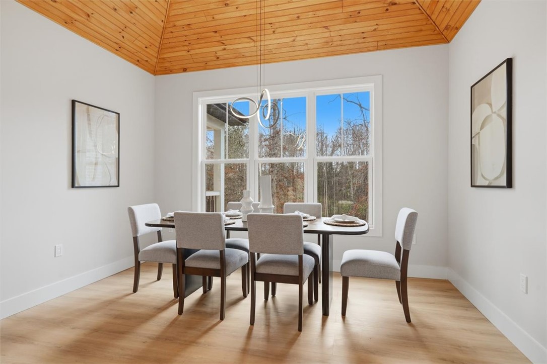 304 Avenue Of Oaks Anderson, SC 29621 - Photo 15 of 38 This dining room features a striking vaulted ceiling and expansive windows for abundant natural light.
