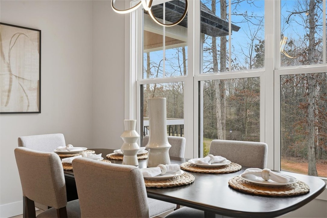 304 Avenue Of Oaks Anderson, SC 29621 - Photo 16 of 38 This bright dining area features expansive windows, perfect for memorable meals with a view.