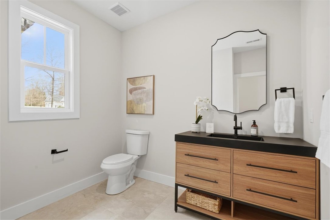 304 Avenue Of Oaks Anderson, SC 29621 - Photo 17 of 38 This clean and bright bathroom features elegant tile flooring and a sleek modern vanity.